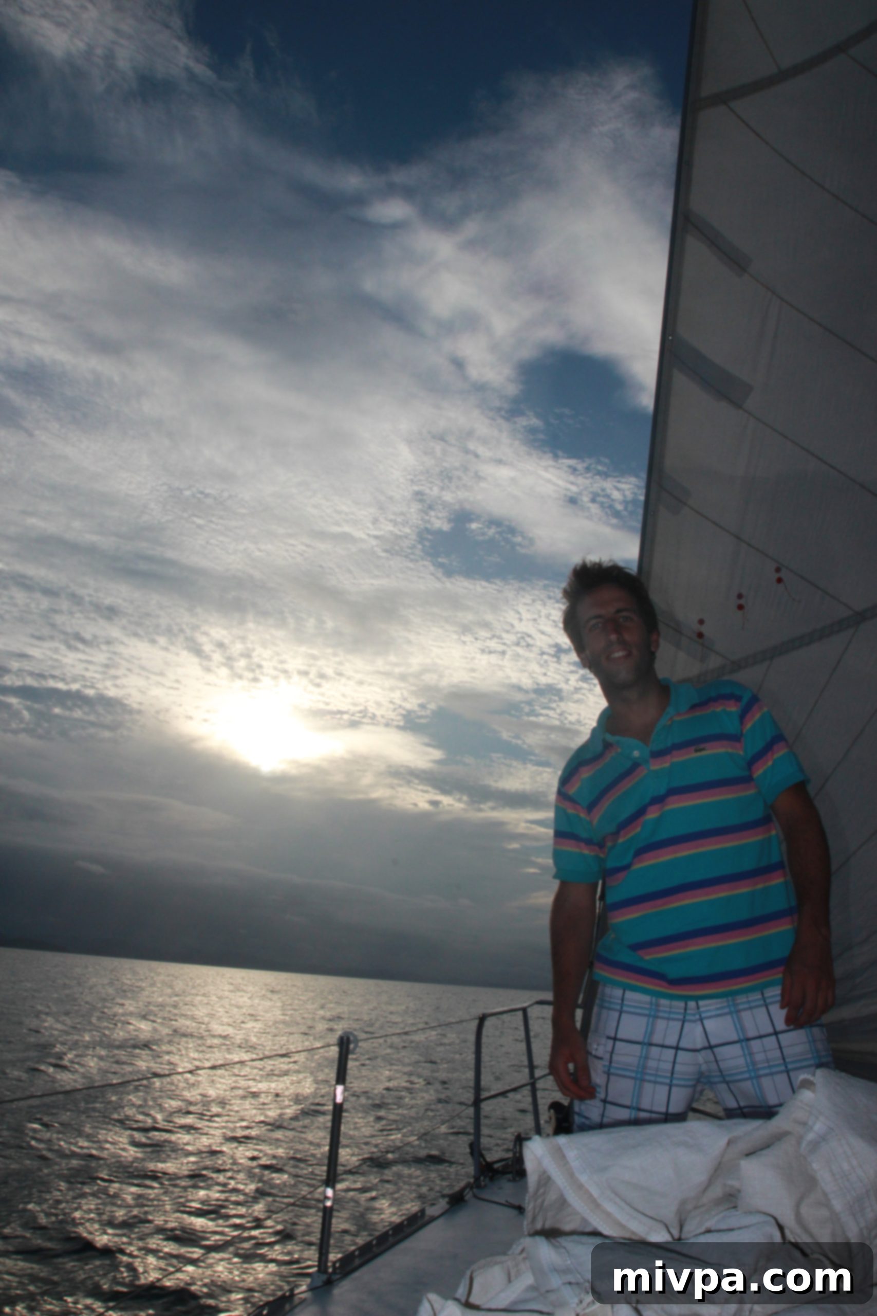 Couple relaxing and watching the ocean from the sailboat, enjoying the tranquility