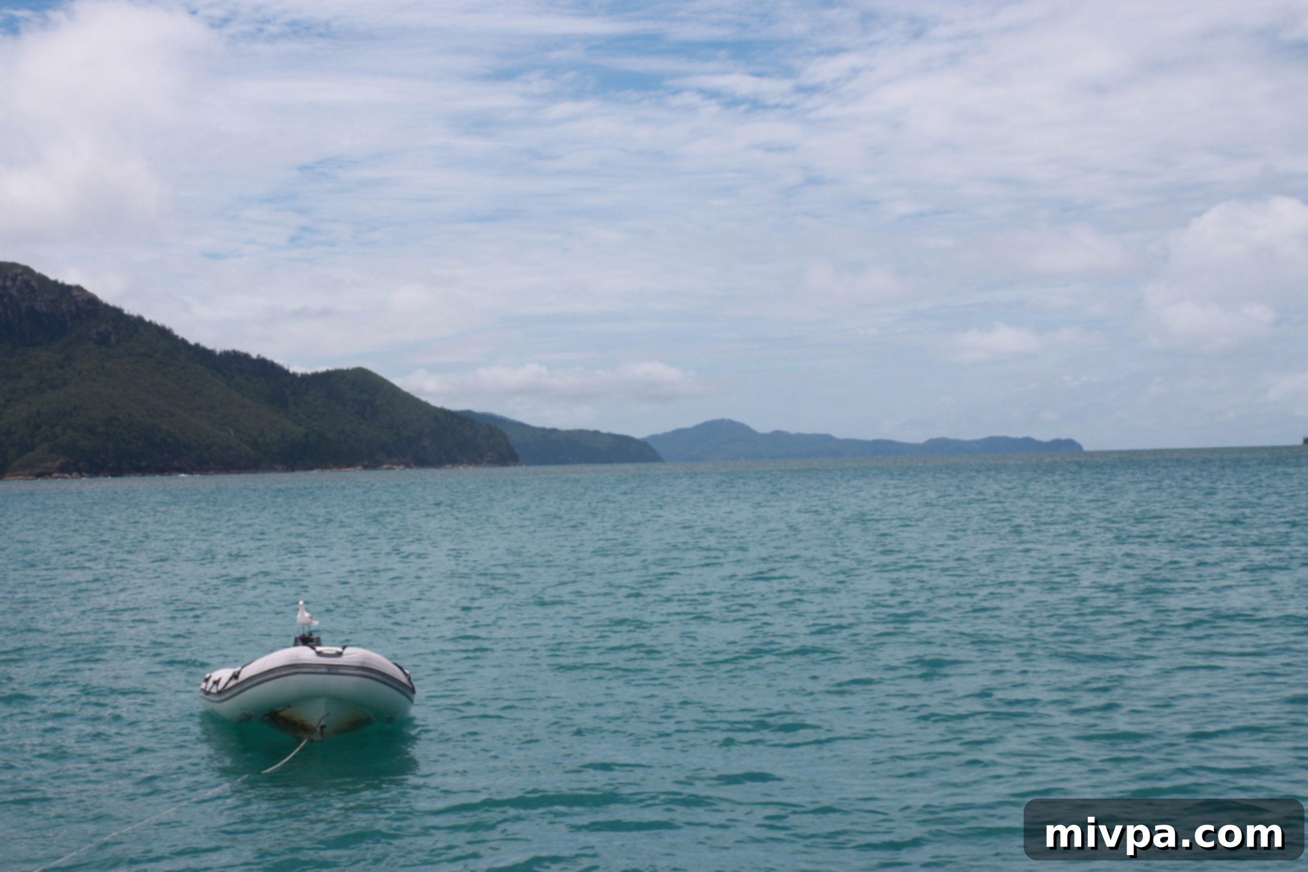 Reflections of sunlight sparkling on the pristine ocean surface of the Whitsundays