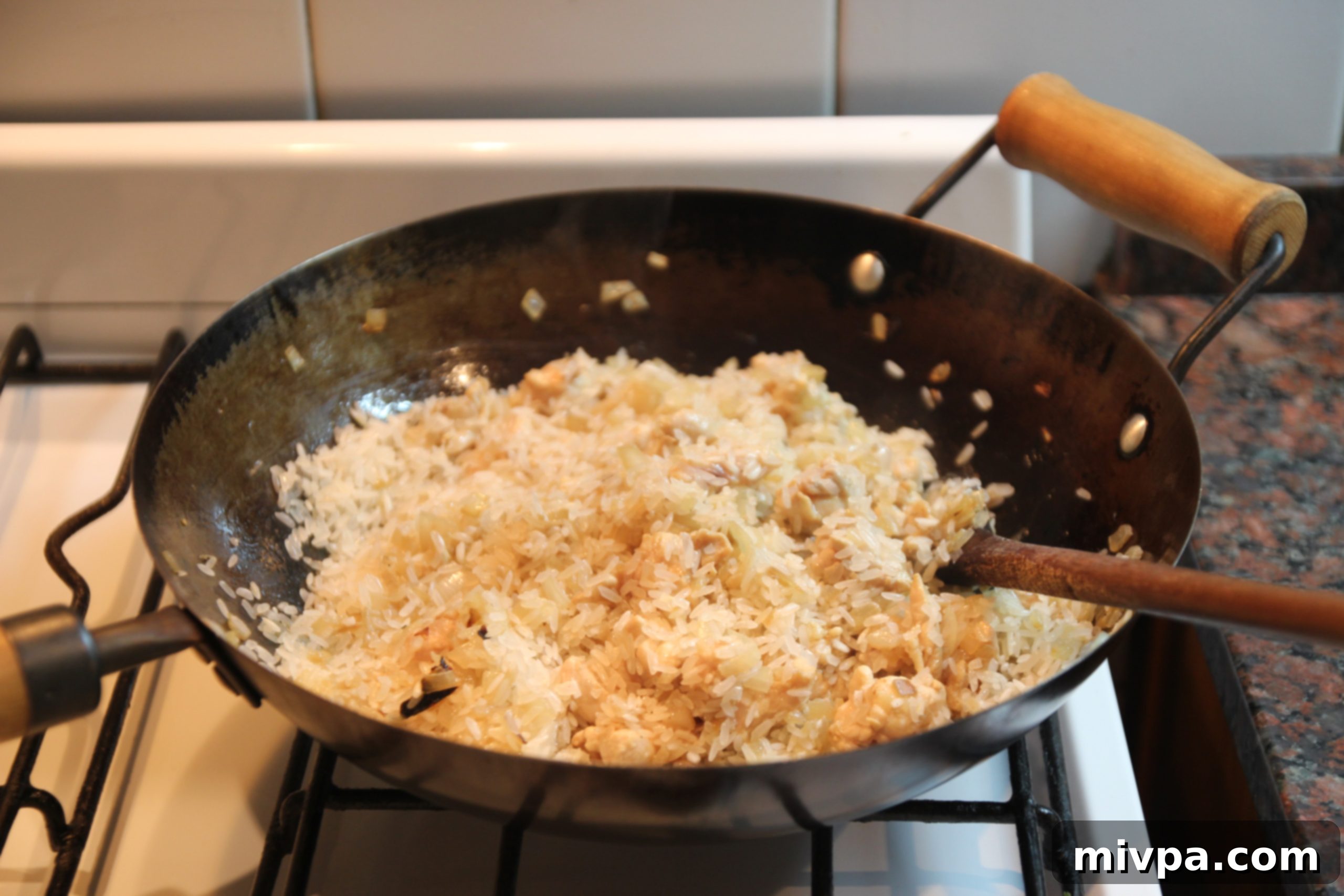Arborio rice added to the chicken and onions, stirring to toast