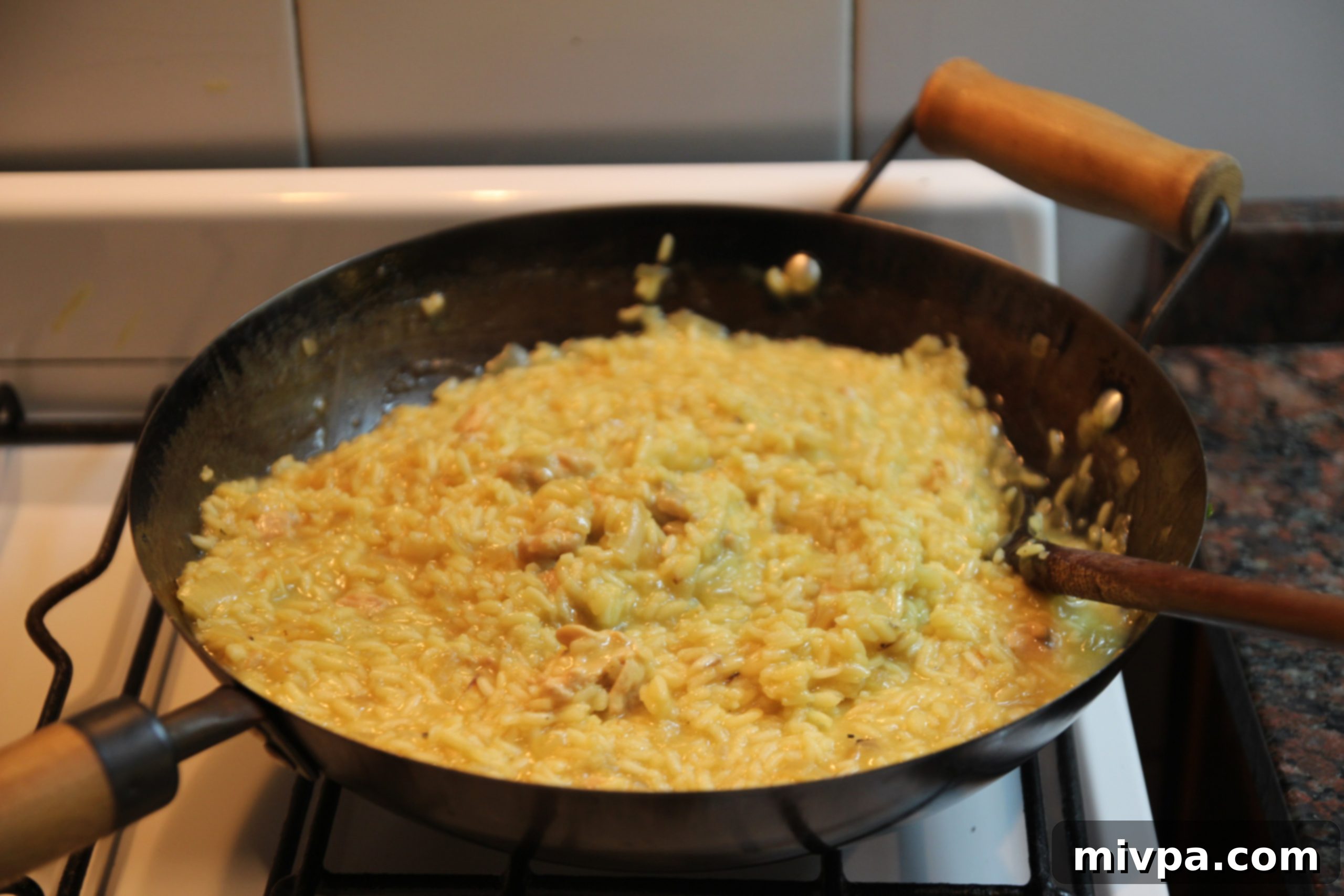 Finished creamy chicken saffron risotto in the wok, perfectly cooked