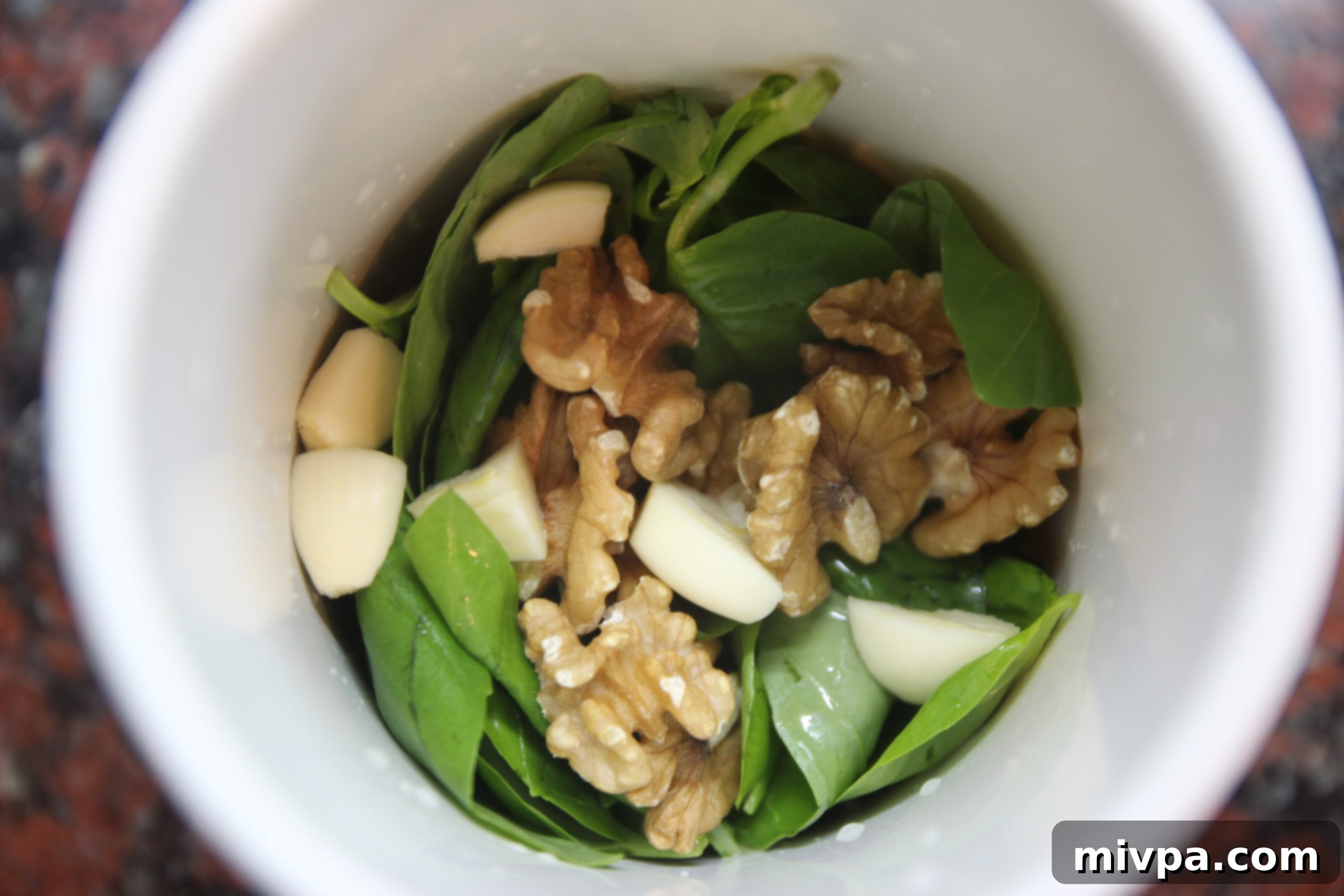 Preparing garlic and basil for the pesto sauce