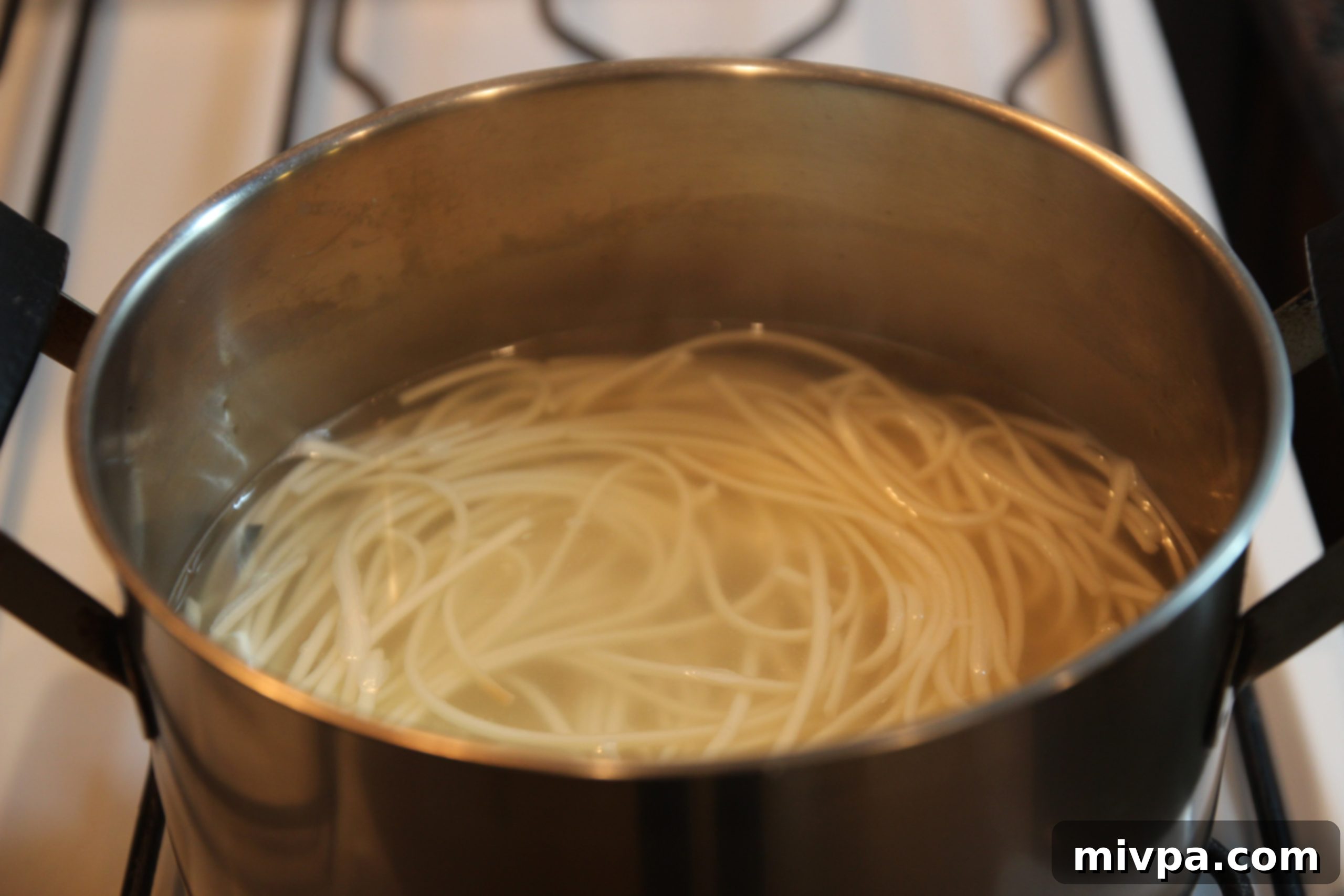 Draining cooked spaghetti in a colander