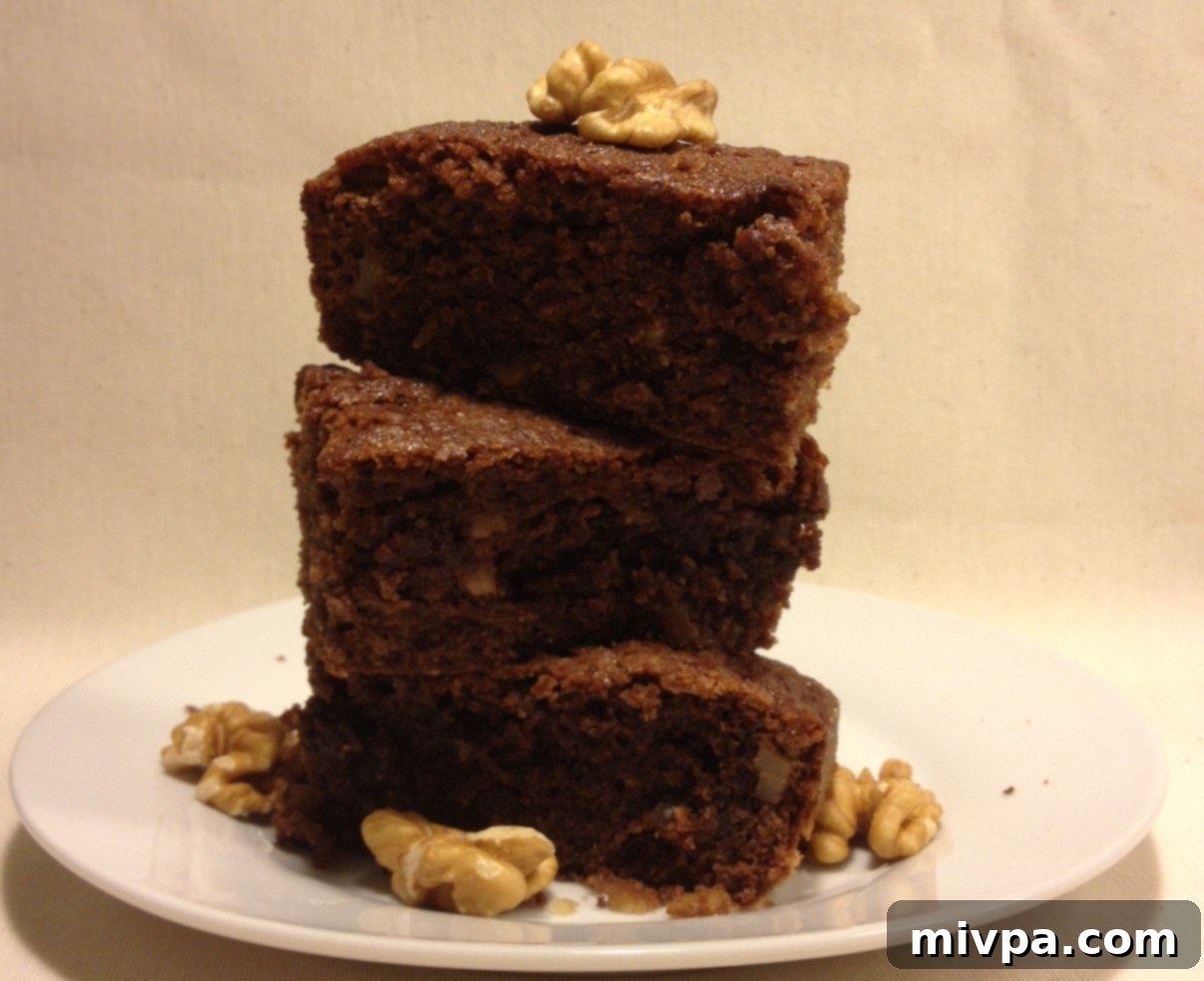Warm, freshly-baked chocolate walnut brownies, perfectly fudgy and ready to be enjoyed.
