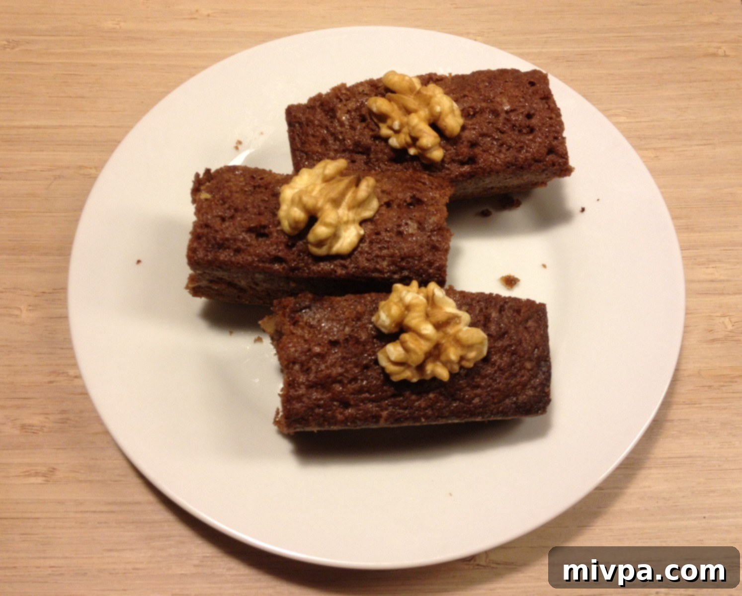 Perfectly cut squares of homemade chocolate walnut brownies, ready to serve.
