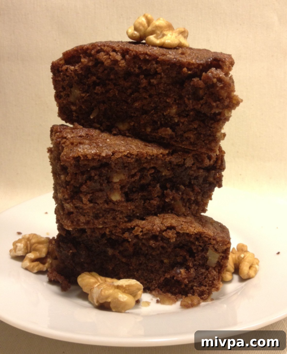 Delicious chocolate walnut brownies arranged on a plate, tempting and inviting.