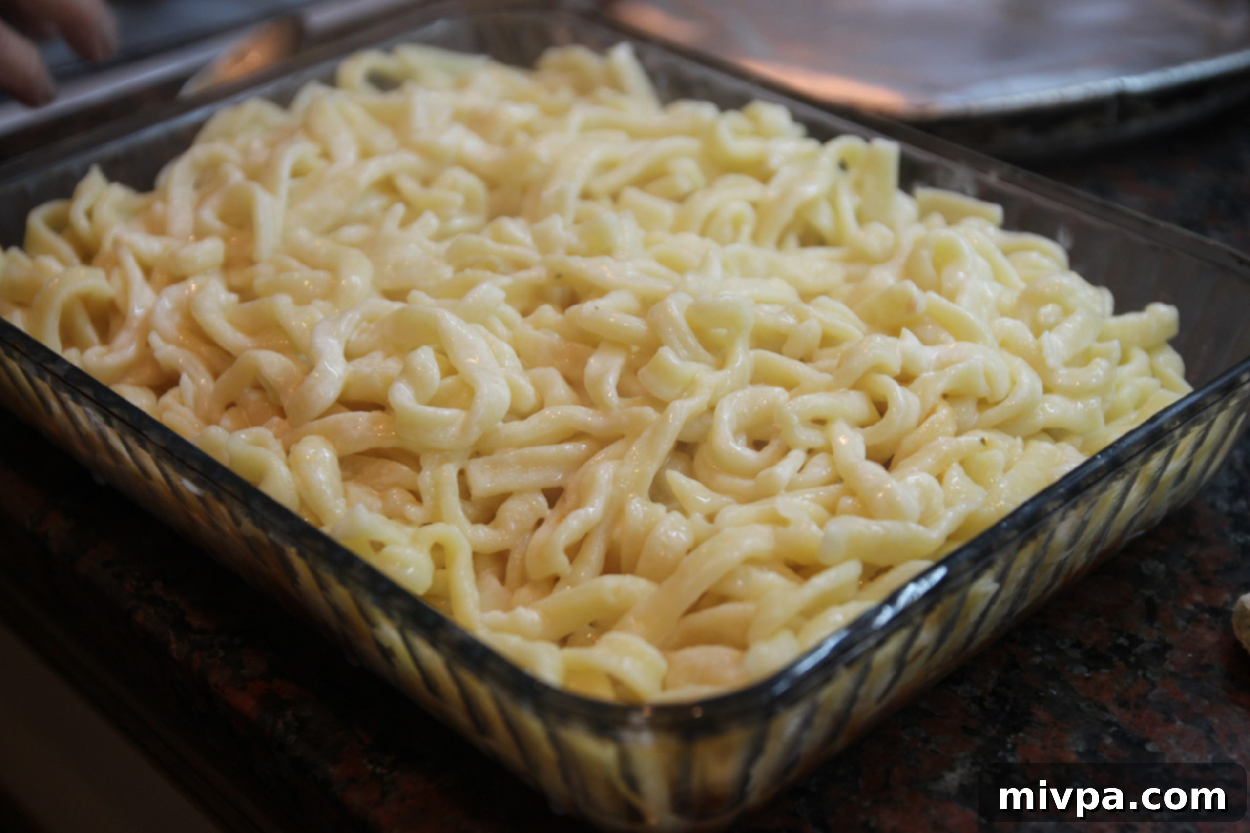 Freshly cooked pasta being drained from boiling water.