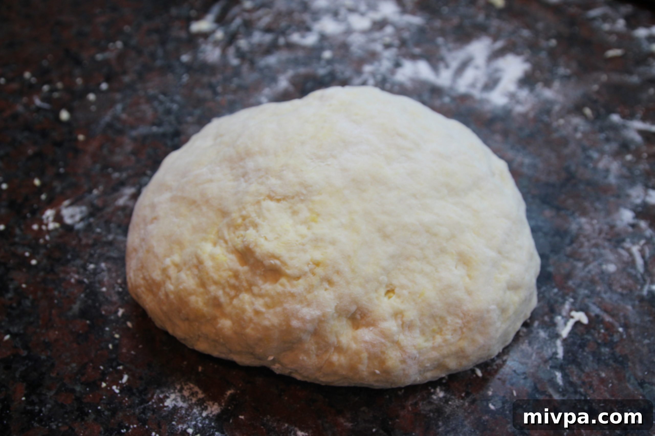 Kneading pasta dough to achieve a smooth consistency.