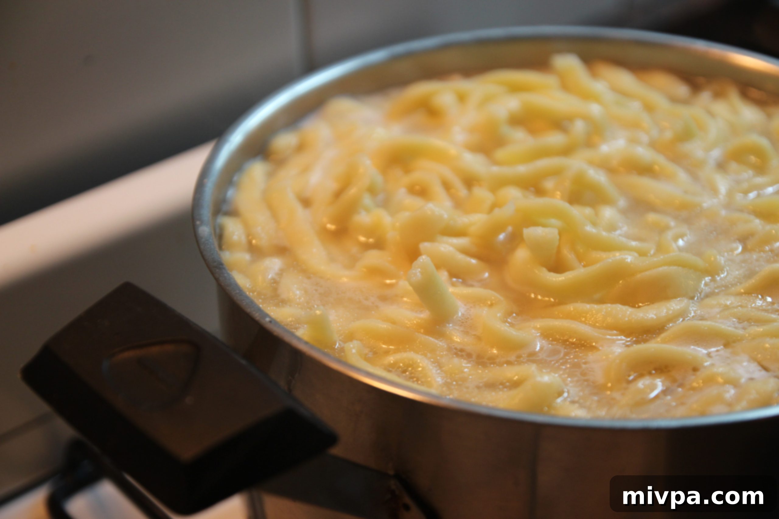 Fresh pasta boiling in a pot of water.