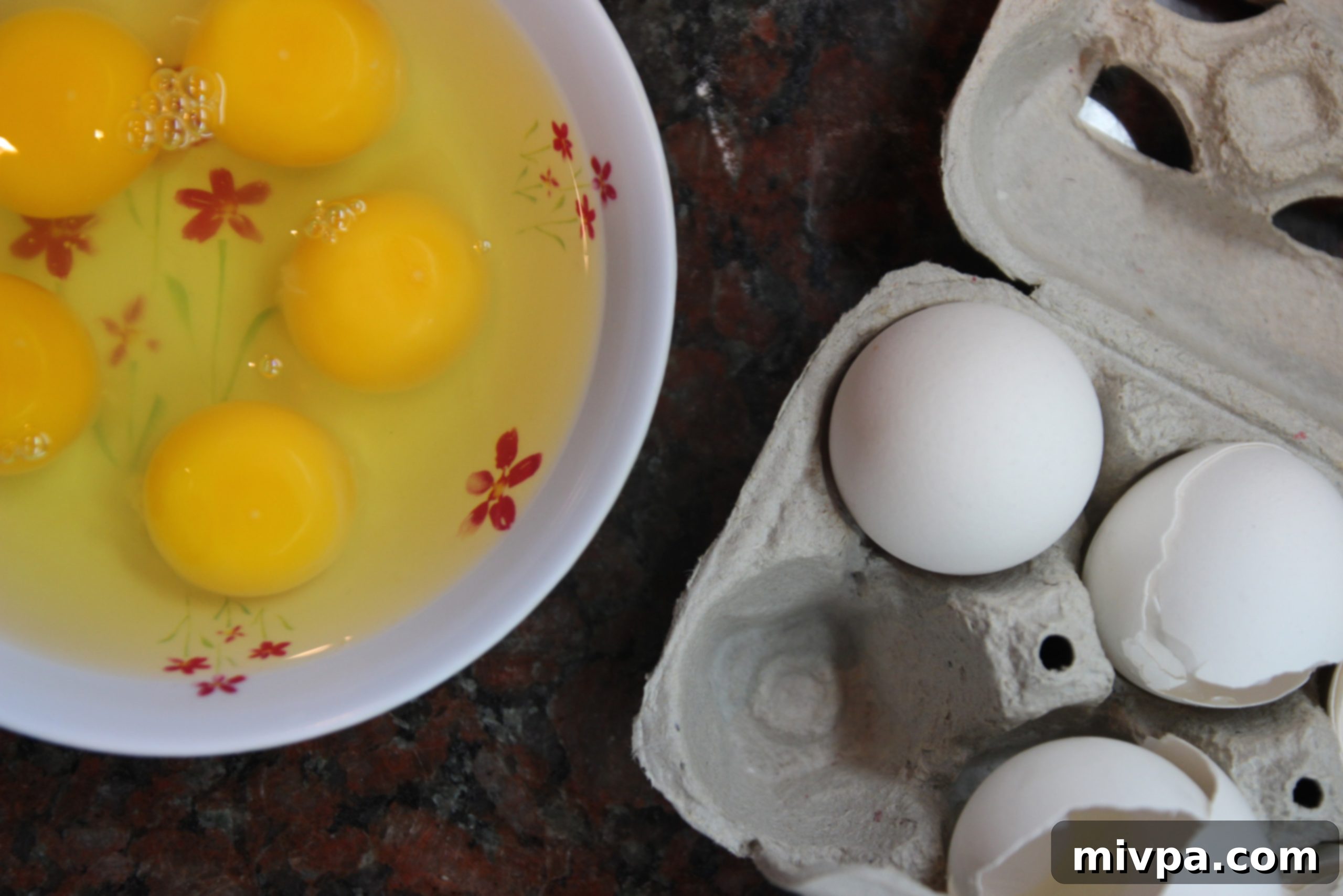 Adding eggs to flour to begin the pasta dough.