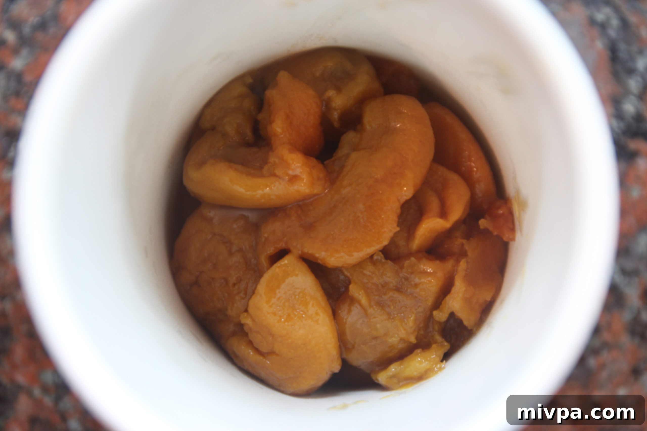 Blending Cooked Peaches into a Smooth Puree