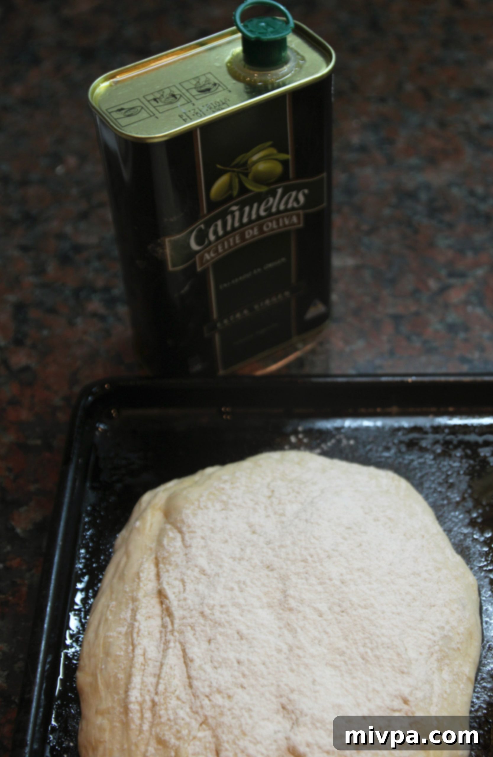 Risen ciabatta dough, light and airy, almost doubled in size in a bowl