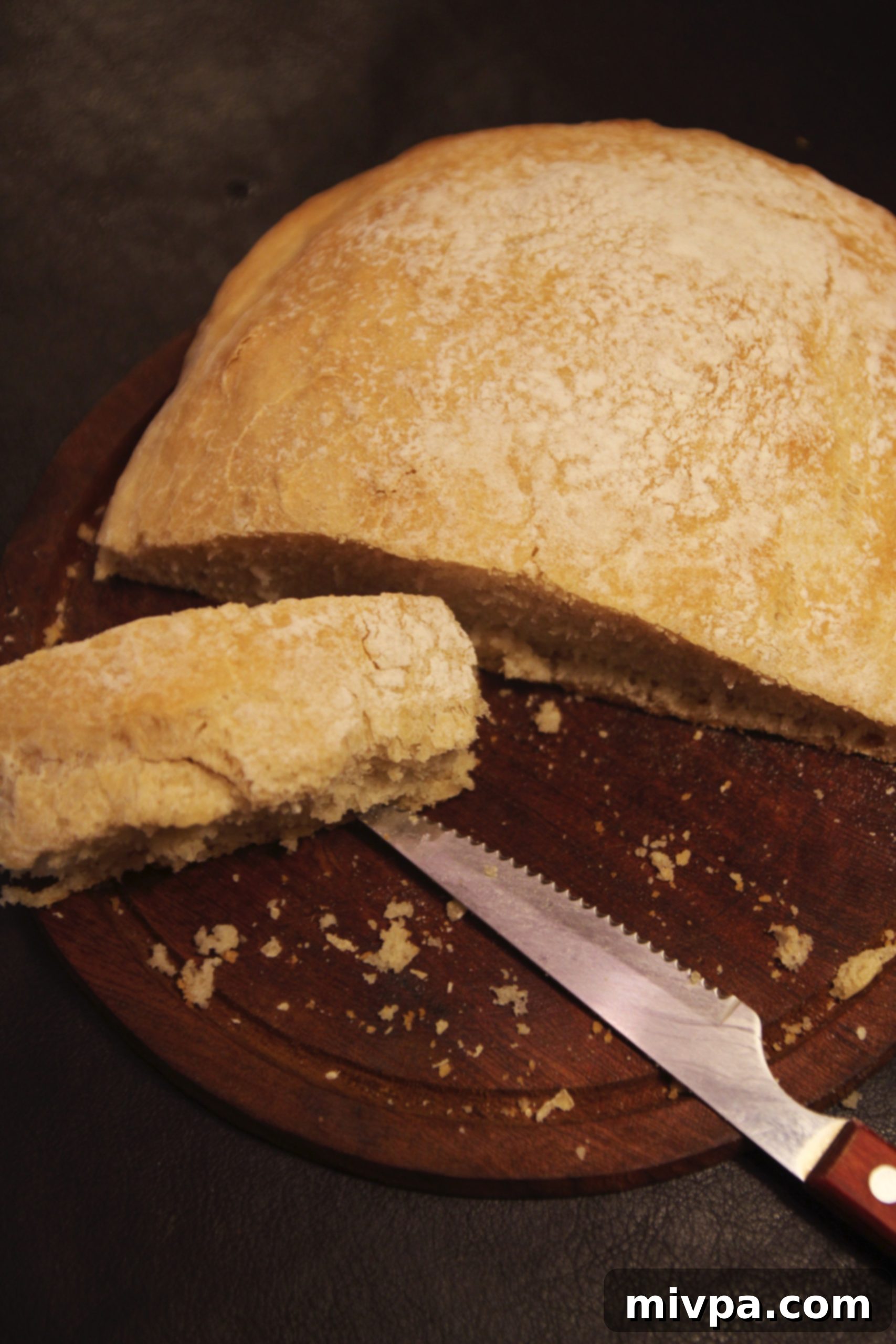 Thick, crusty slices of warm homemade ciabatta bread on a cutting board