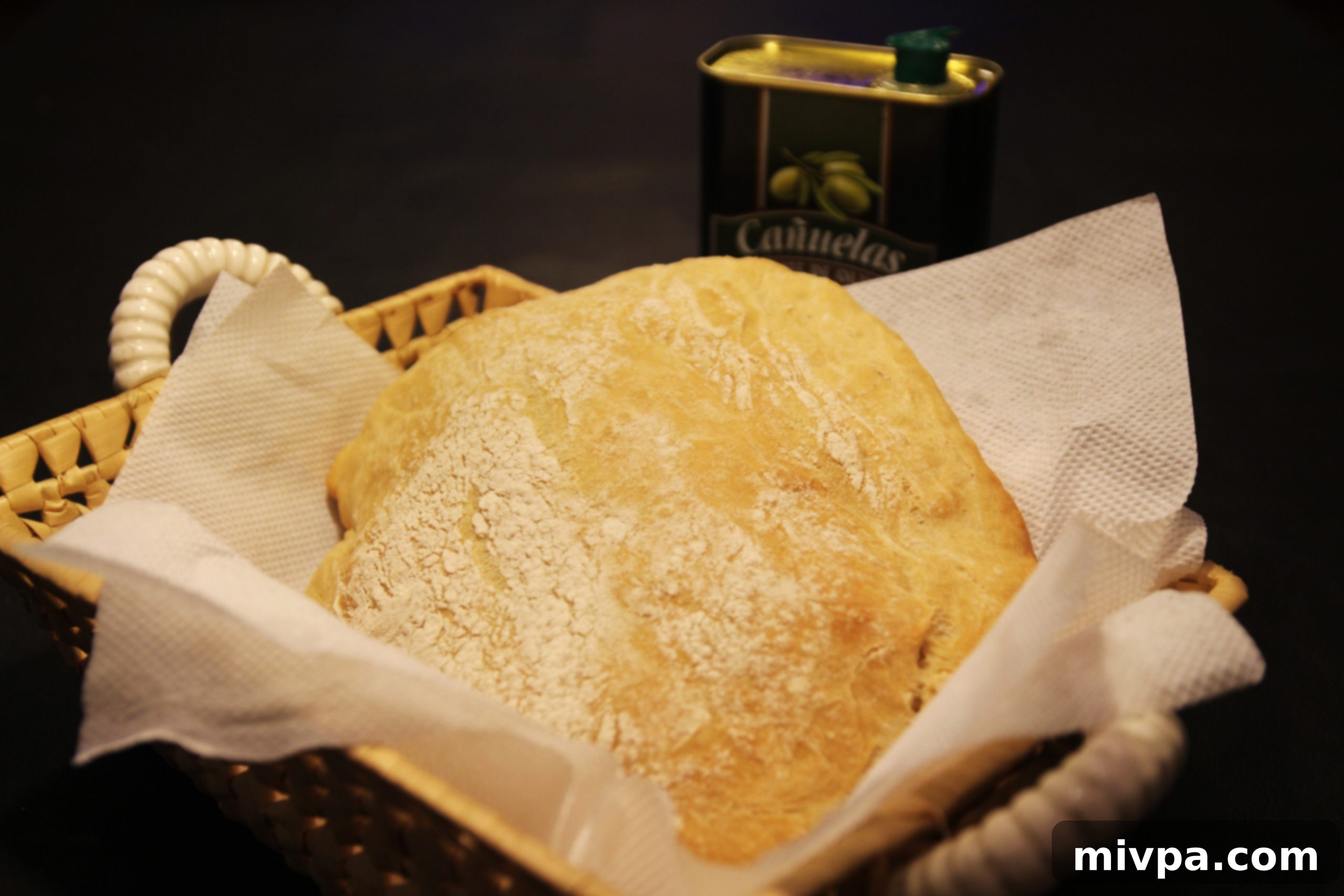 Fresh ciabatta bread, perhaps with a spread, evoking rustic charm and wholesome goodness