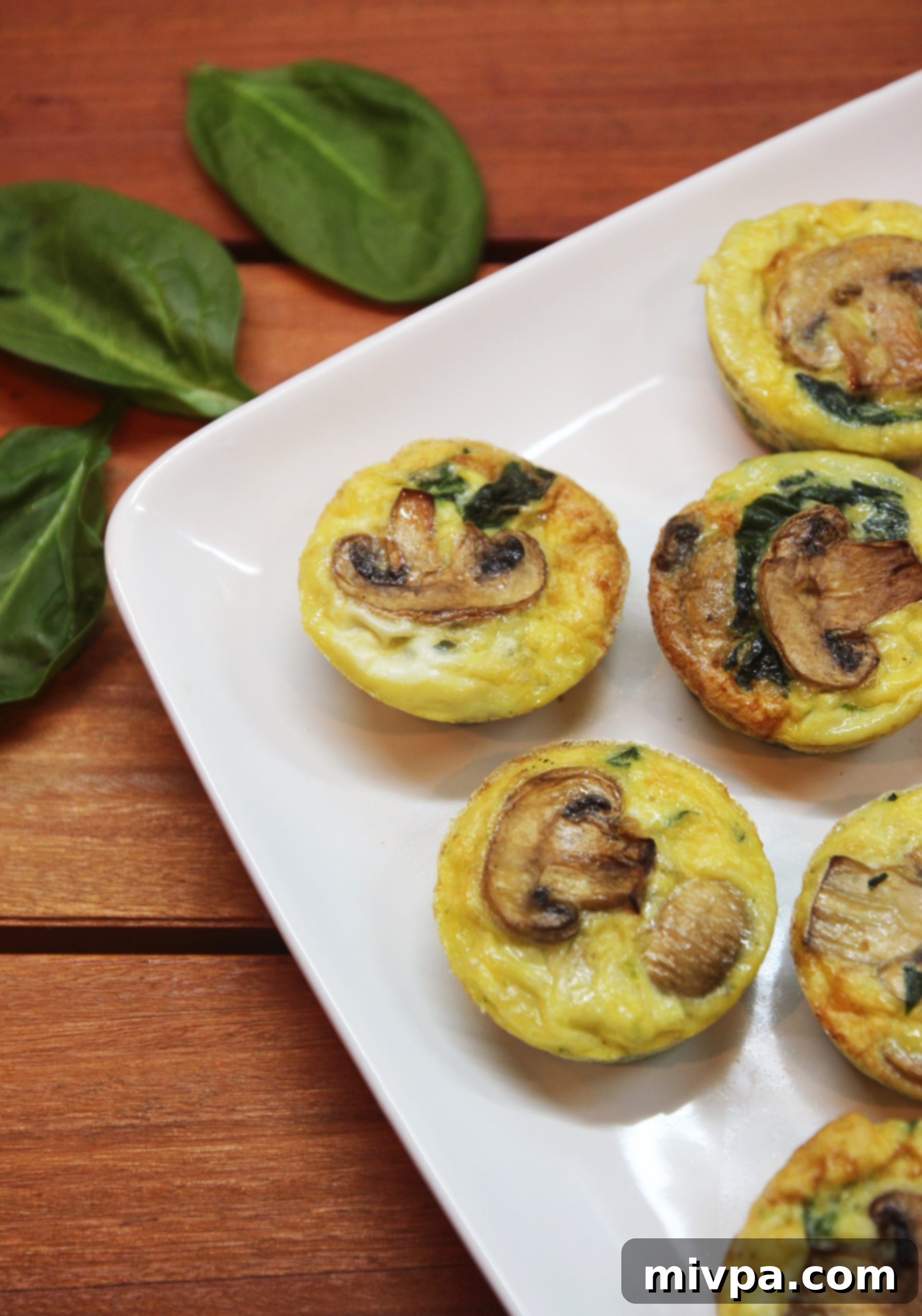 Two Mushroom Spinach Quiche Cups on a plate