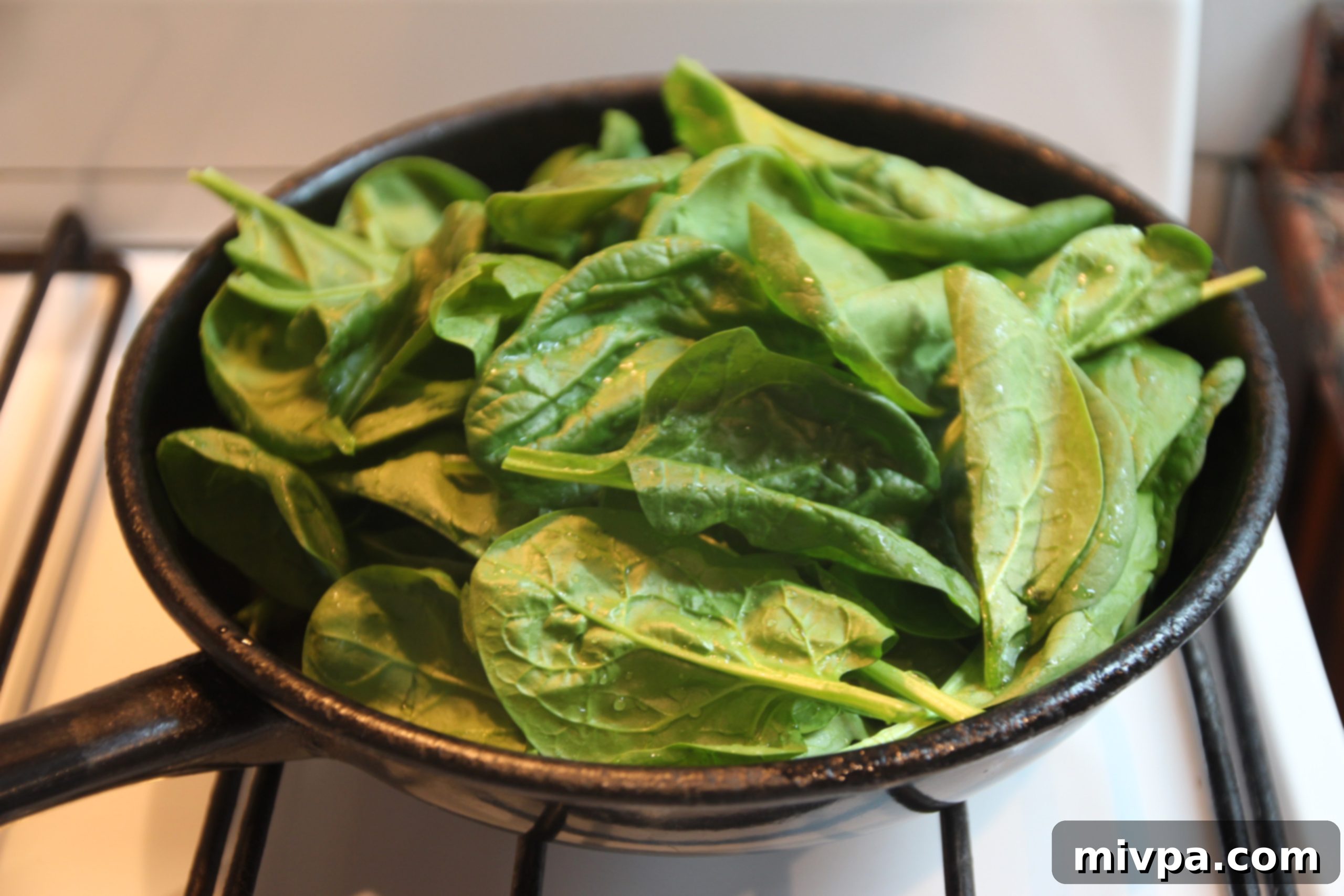 Wilting spinach in a frying pan