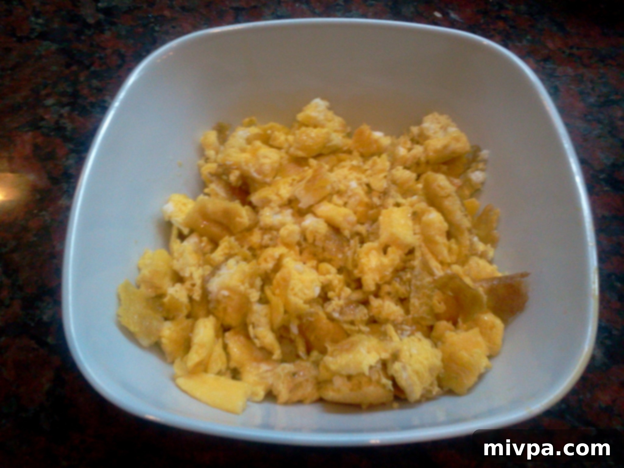 Cooked omelette sliced into small, even pieces, ready to be mixed into the fried rice.