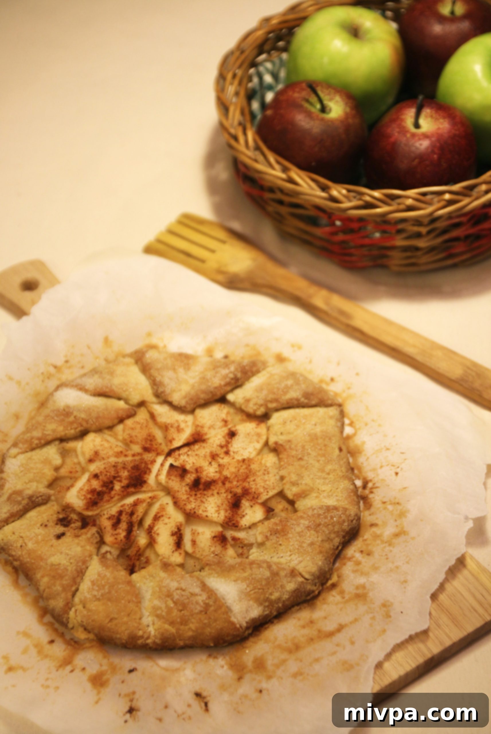 Close-up of a freshly baked Apple Cinnamon Galette, showcasing its flaky golden crust and tender apple filling.