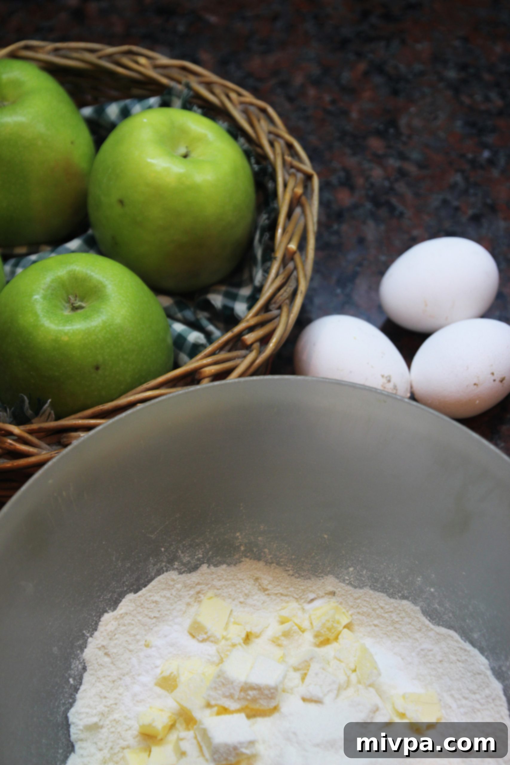 A close-up shot of the raw Apple Cinnamon Galette before baking, with thinly sliced apple pieces neatly arranged within the pastry.