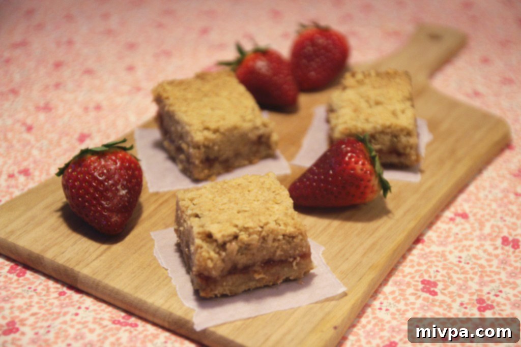 The strawberry oatmeal bars baking in the oven, showing the golden-brown crust.