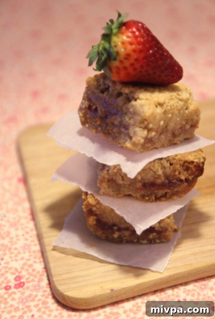 Strawberry oatmeal bars, freshly baked and golden brown, cooling on a wire rack.