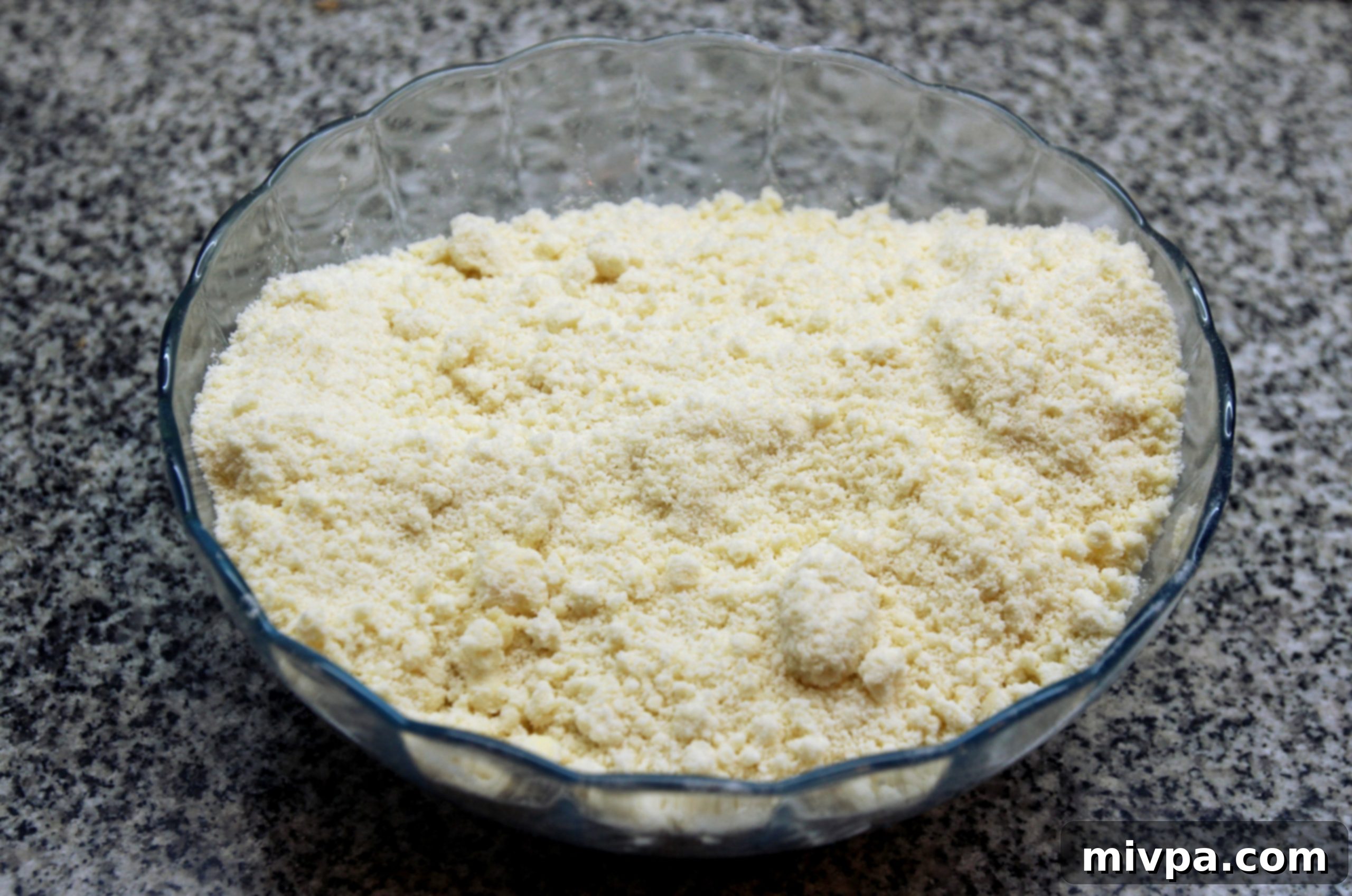 Rubbing butter into flour to create crumbly dough