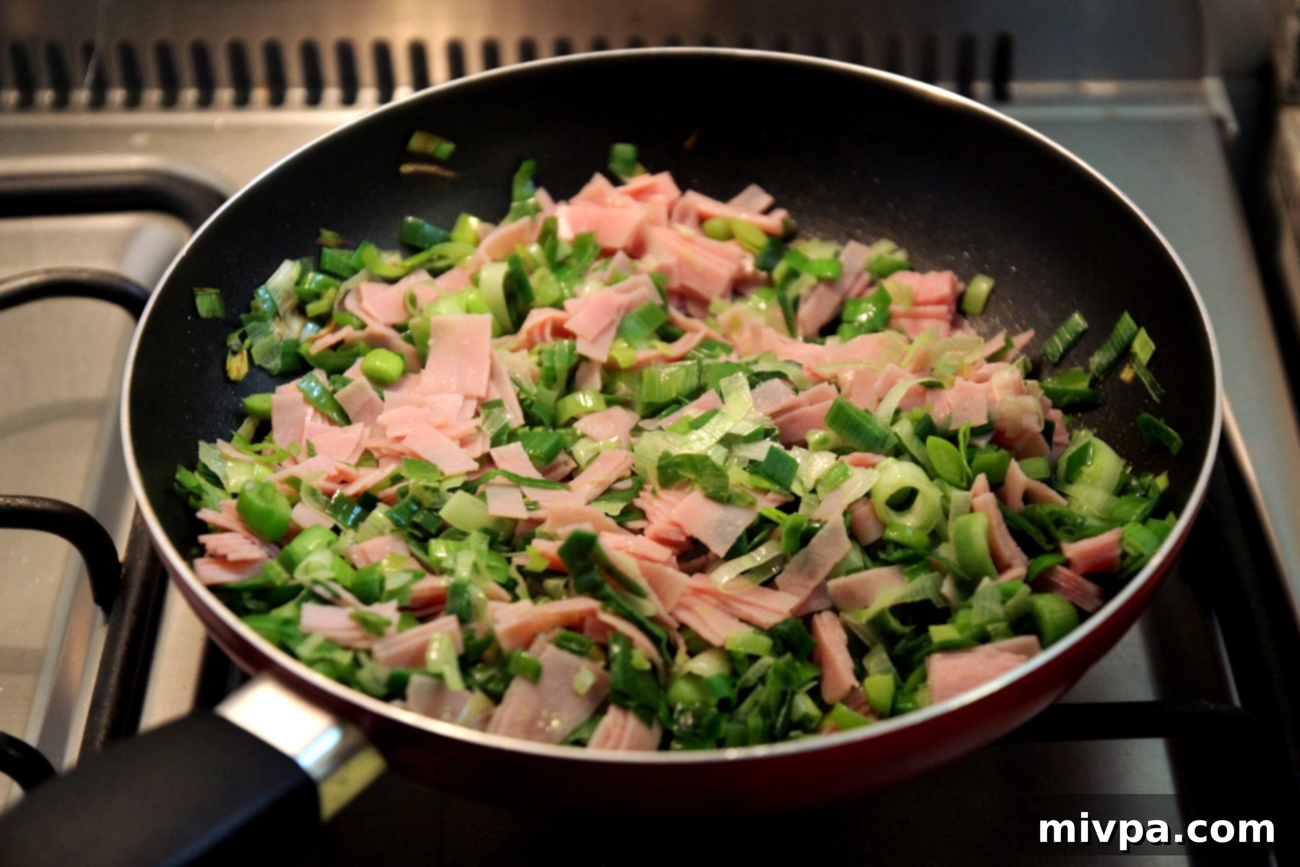 Seasoning leek and ham mixture with salt and pepper