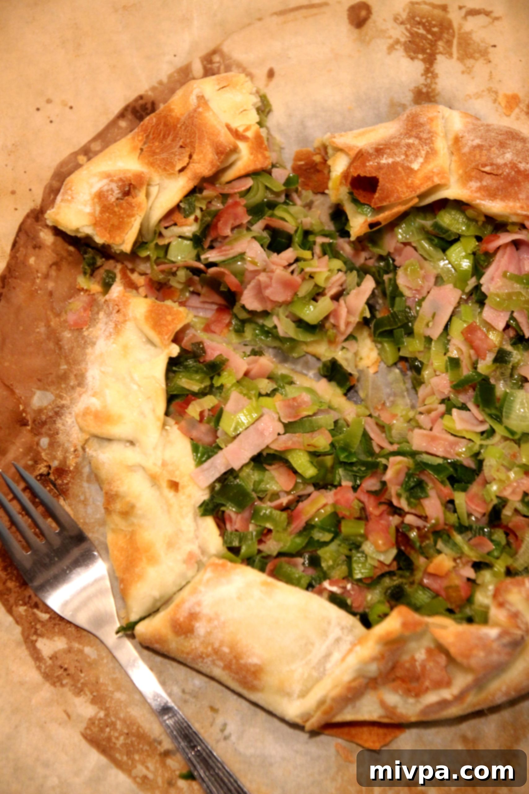Close up of a slice of Leek and Ham Tart on a plate