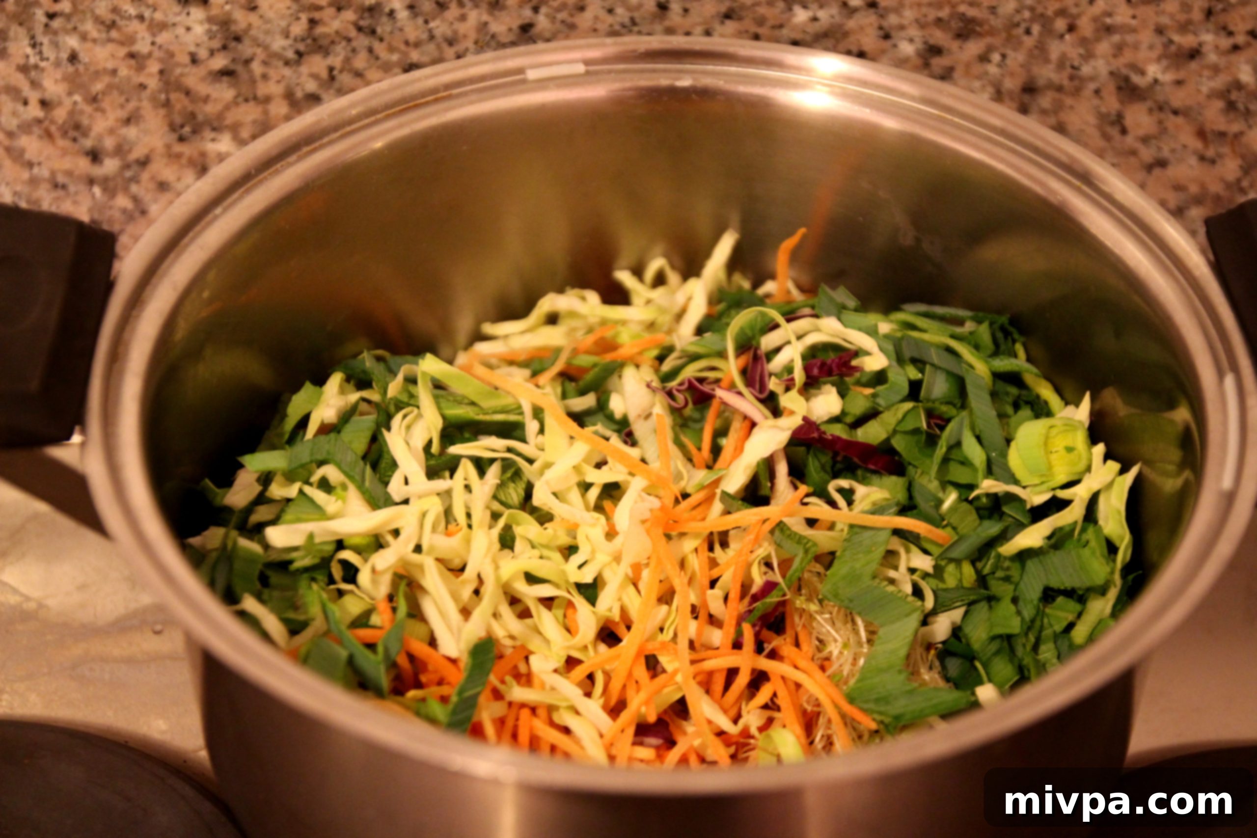 Step 5: Sautéing leeks and mixed vegetables in a large pot for the noodle dish