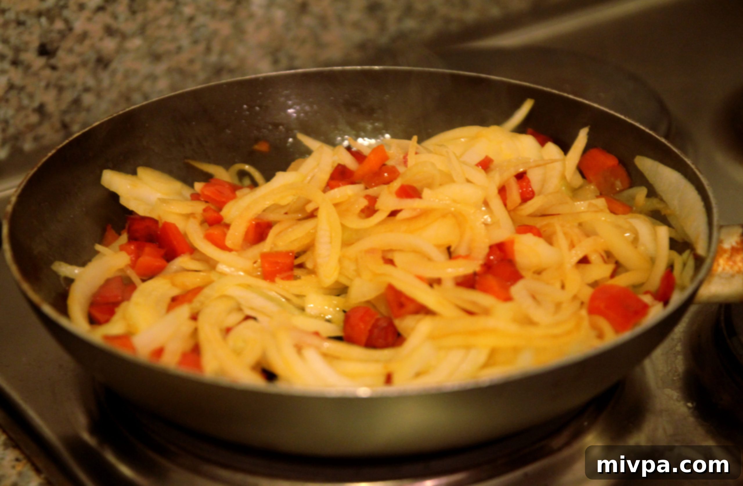 Sautéing onions and red bell peppers for tart