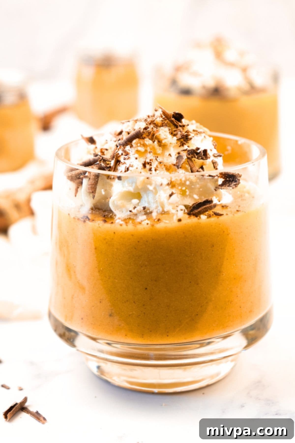 Creamy Pumpkin Pudding (Gluten-Free, Dairy-Free) Up close view of a pumpkin pudding in a glass jar, perfectly chilled.