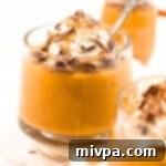 Guilt-Free Pumpkin Indulgence 2 Glasses of creamy pumpkin pudding, ready to be served.