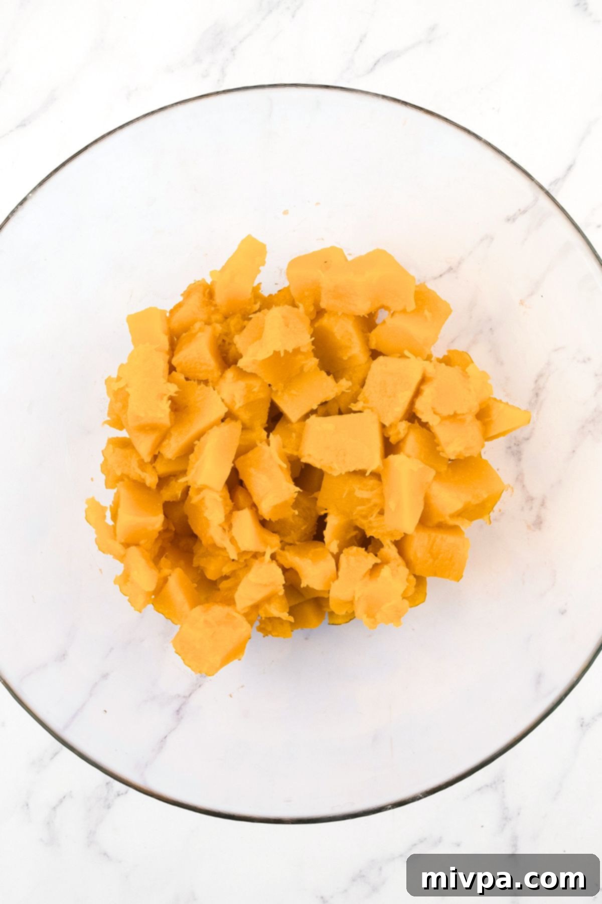 Easy Pumpkin Pudding Recipe (Gluten-Free, Dairy-Free) Cooked pumpkin cubes in a glass bowl, ready for pureeing.