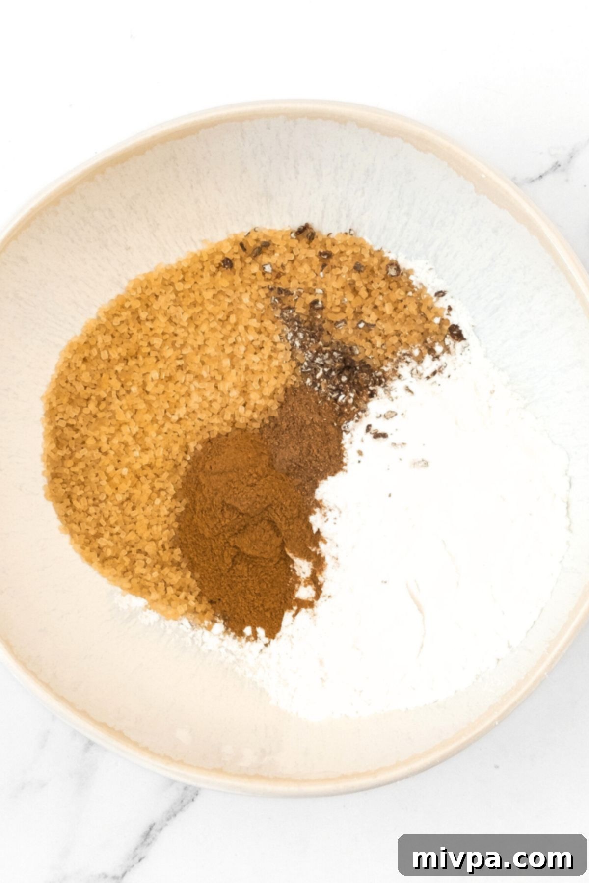 Creamy Pumpkin Pudding (Gluten-Free, Dairy-Free) A bowl containing brown sugar, ground cinnamon, ground nutmeg, and cardamom.