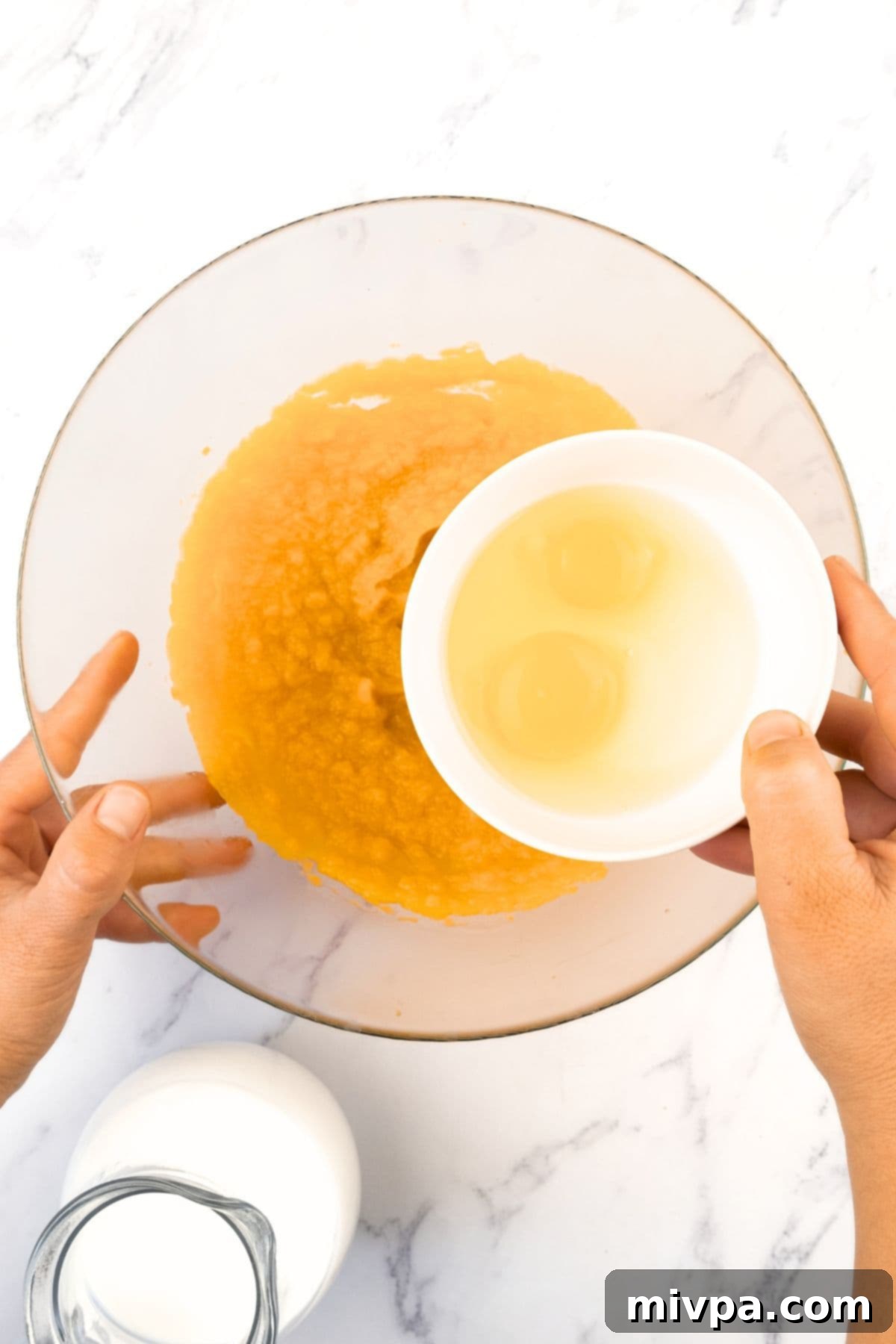 Gluten Dairy-Free Pumpkin Pudding Pouring beaten eggs into a bowl of pumpkin puree and almond milk mixture.
