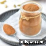 Whip Up Your Own Gluten Free Vegan Apple Pie Spice 2 A jar of apple pie spice on parchment paper, ready to be used in delicious fall recipes.