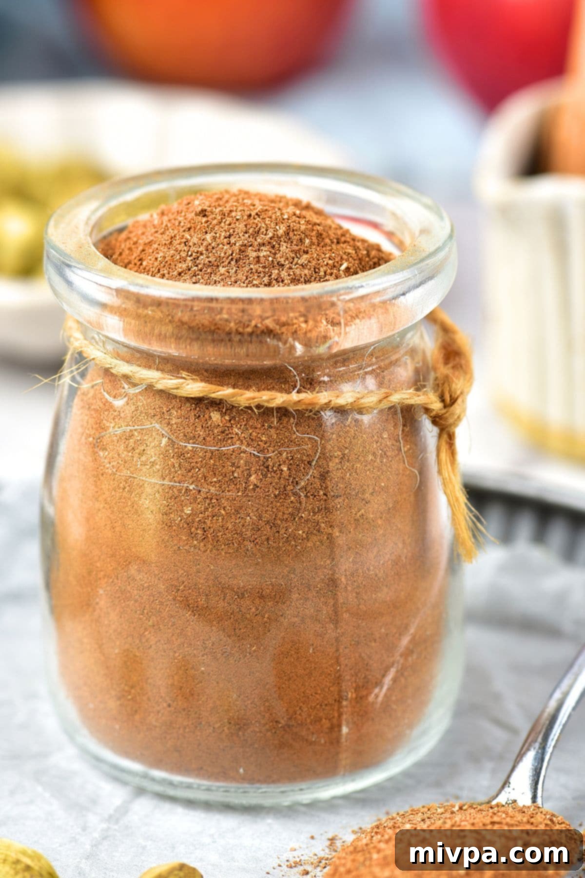 DIY Apple Pie Spice (Gluten-Free, Vegan) A rustic jar filled with homemade DIY apple pie spice blend, ready for use in delicious recipes.