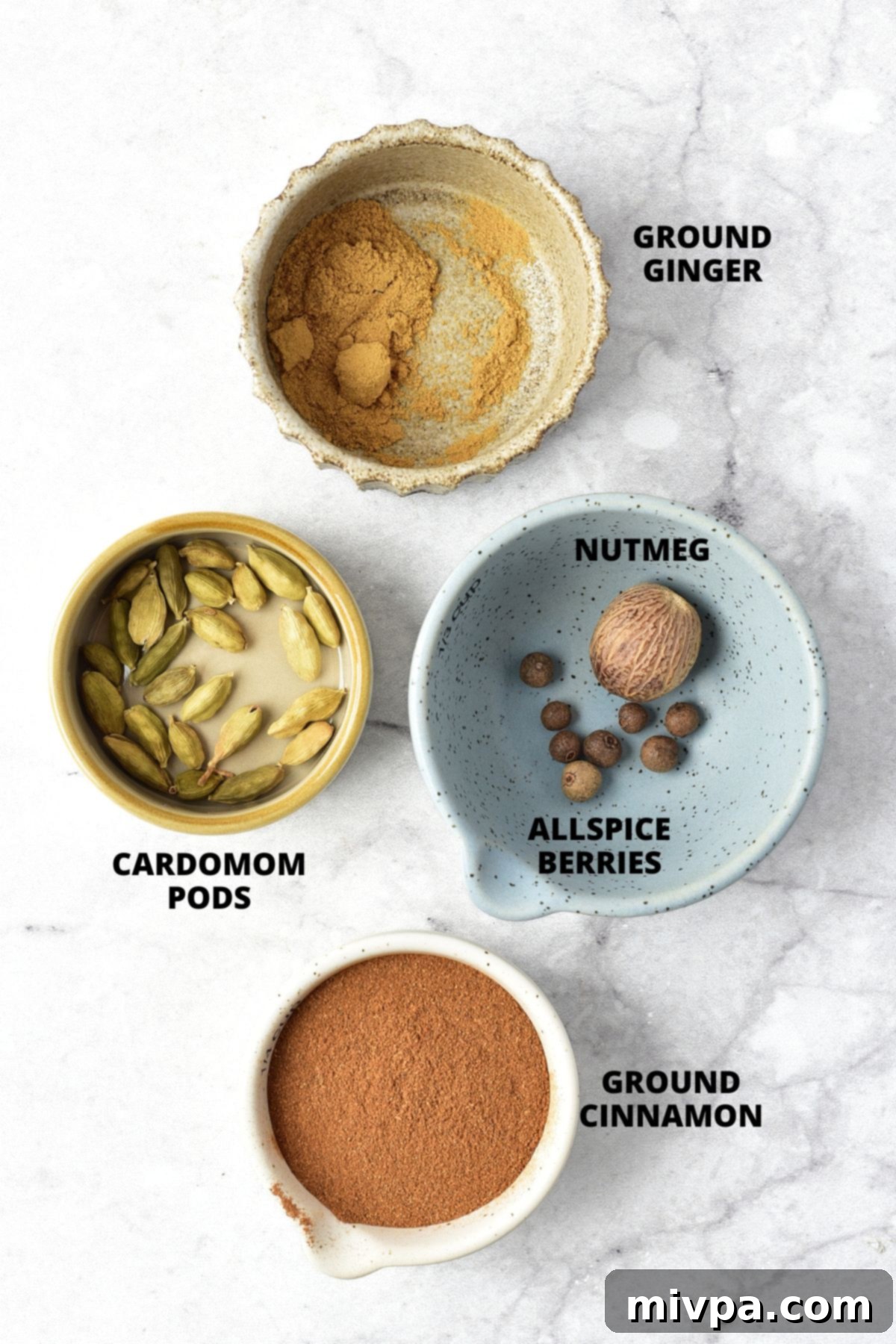 Homemade Apple Pie Spice Recipe (Gluten-Free, Vegan) Ingredients for apple pie spice recipe laid out beautifully on a marble board, ready for blending.