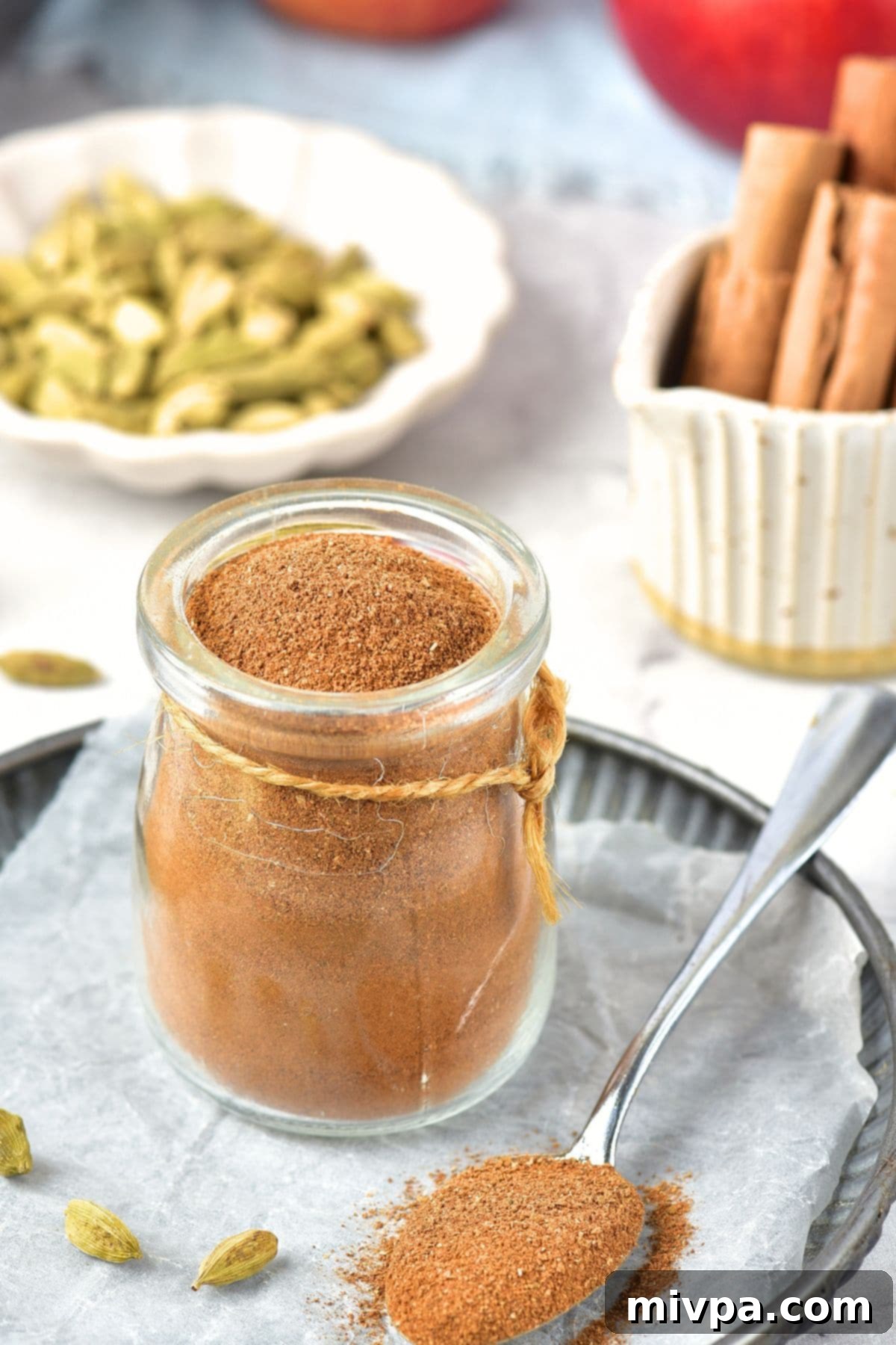 Apple Pie Spice Mix (Gluten-Free, Vegan) A charming jar filled with a freshly prepared apple pie spice mix, sealed and ready for storage or immediate use.