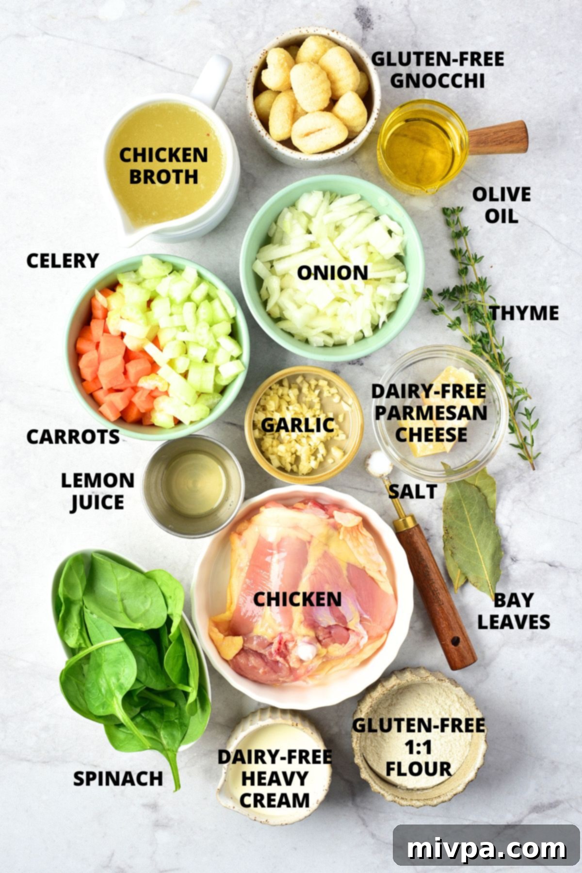 Creamy Gluten-Free Dairy-Free Chicken Gnocchi Soup Recipe Ingredients A selection of fresh, uncooked ingredients including chicken, vegetables, and gnocchi laid out on a marble board for the gluten-free chicken gnocchi soup recipe.