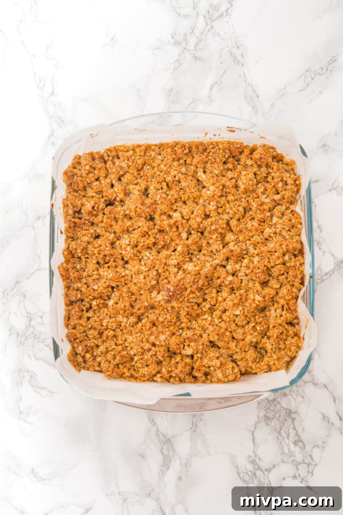 Apple Oat Bars Recipe (Gluten-Free, Dairy-Free) The apple oatmeal bars with the crumble topping sprinkled over the apple filling, ready for their final bake to golden perfection.