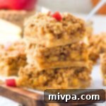 A stack of apple oatmeal bars on wooden board