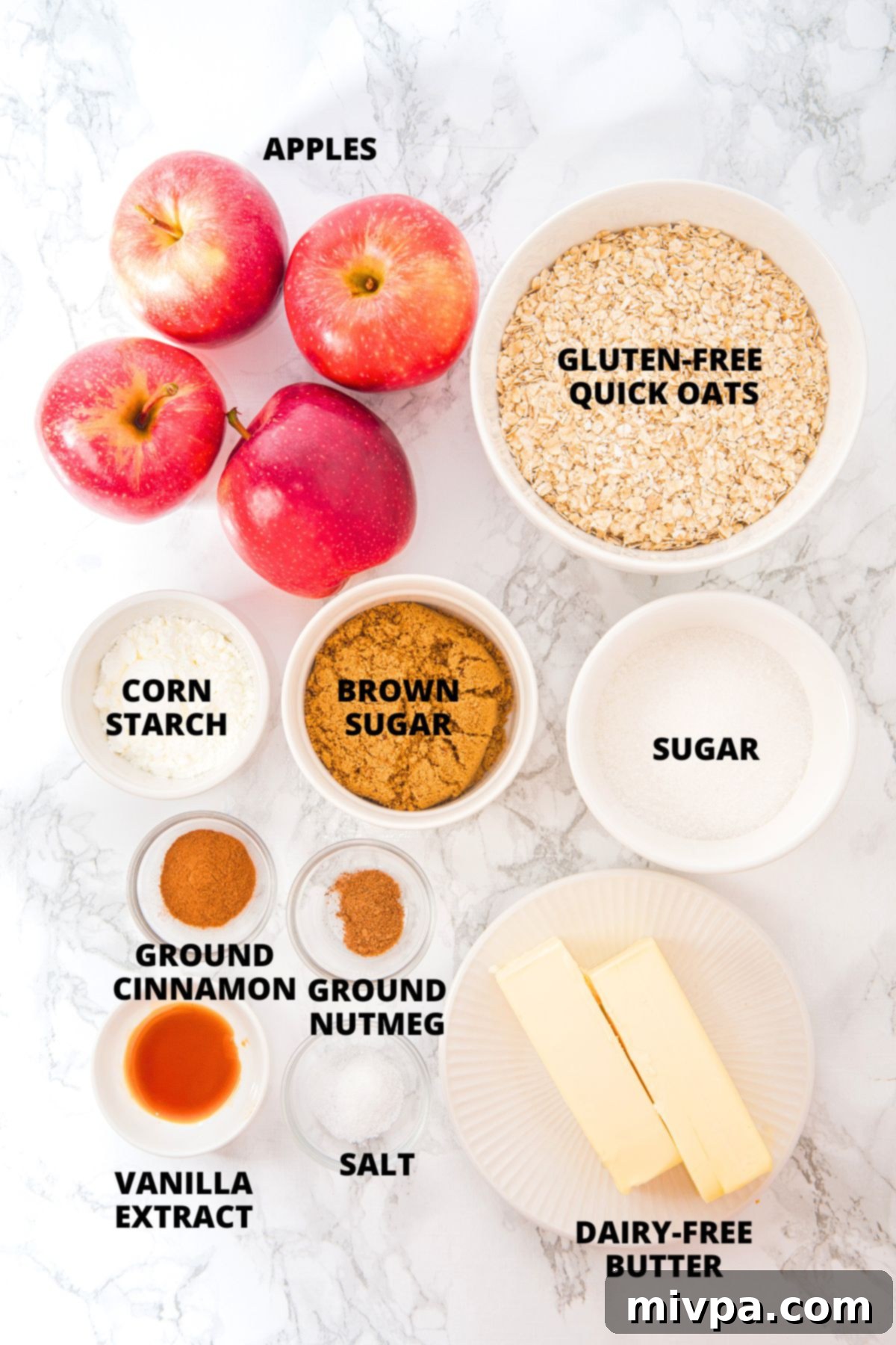 Apple Oatmeal Bars Recipe (Gluten-Free, Vegan) A beautiful flat lay of all the fresh and dry ingredients required for making apple oatmeal bars, neatly arranged on a pristine marble board.