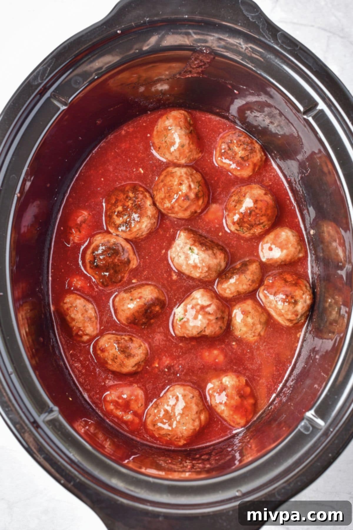 Slow Cooker Cranberry Meatballs (Gluten-Free, Dairy-Free) Meatballs in cranberry sauce in crockpot