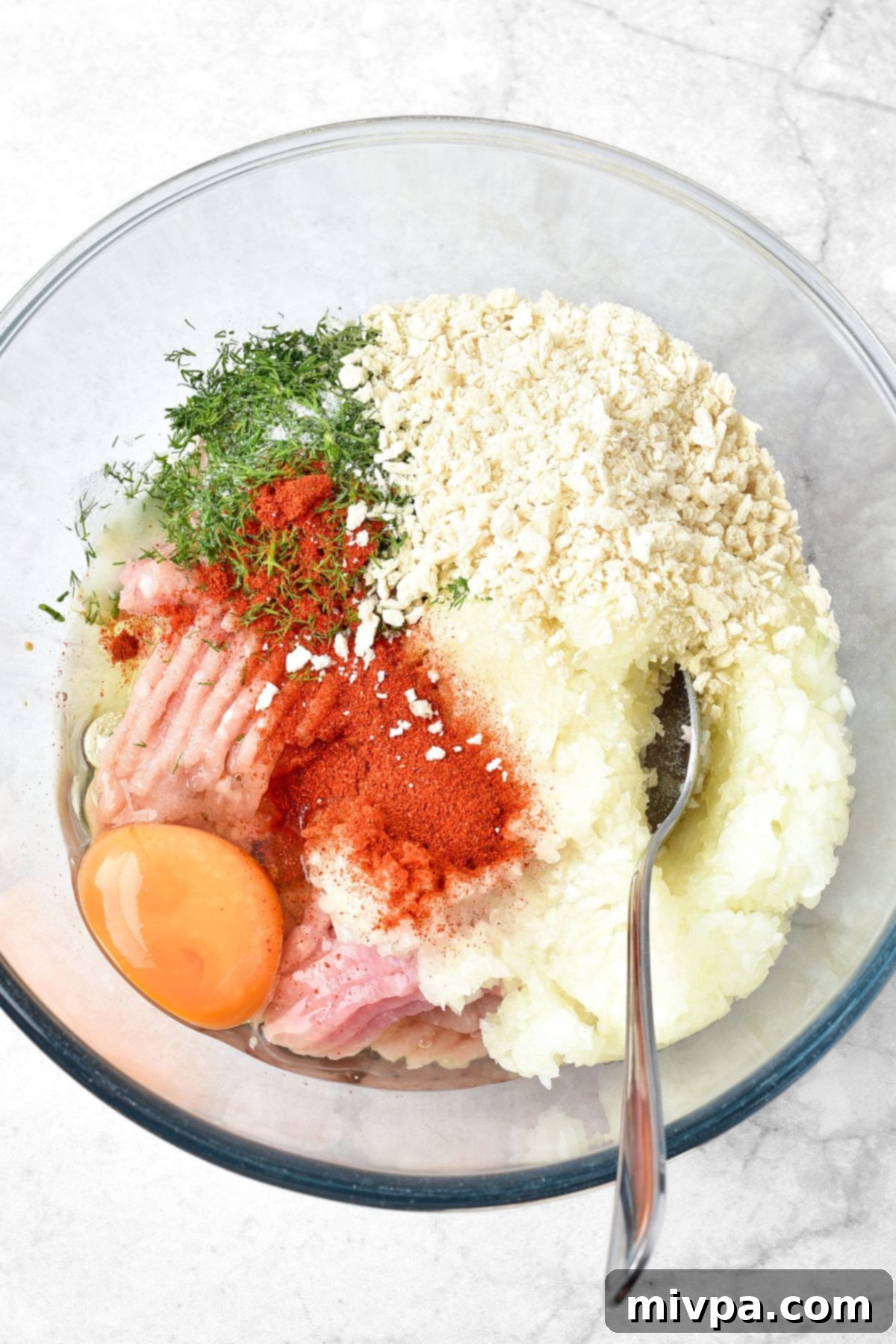 How to Make Cranberry Meatballs (Gluten-Free, Dairy-Free) Egg, ground beef, onions, breadcrumbs, dill and paprika in bowl