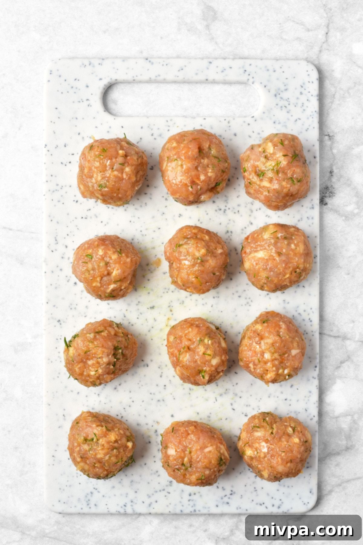 Cranberry Meatball Recipe (Gluten-Free, Dairy-Free) Uncooked meatballs on chopping board