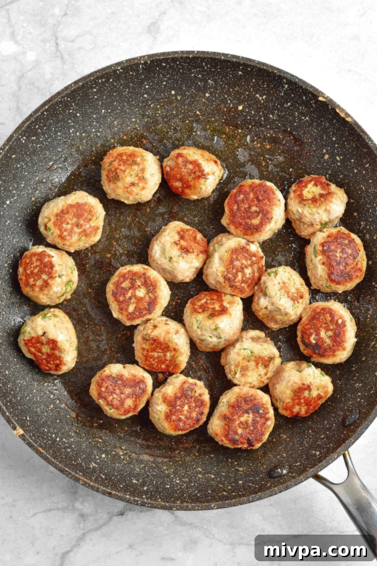 Gluten Dairy-Free Cranberry Meatballs Searing meatballs in skillet