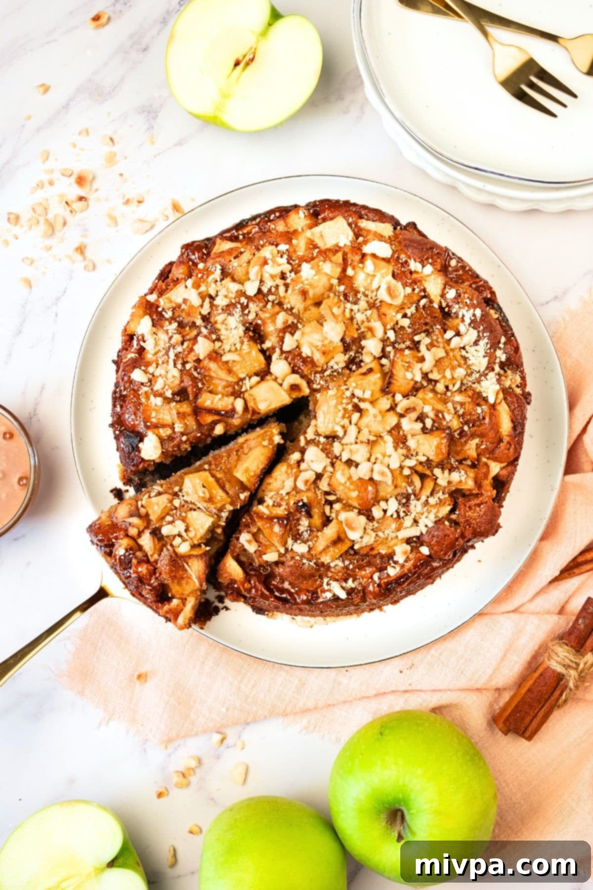 Gluten-Free Äppelkaka for Cozy Fall Moments Top-down view of a beautifully baked äppelkaka on a white plate, ready to be served.