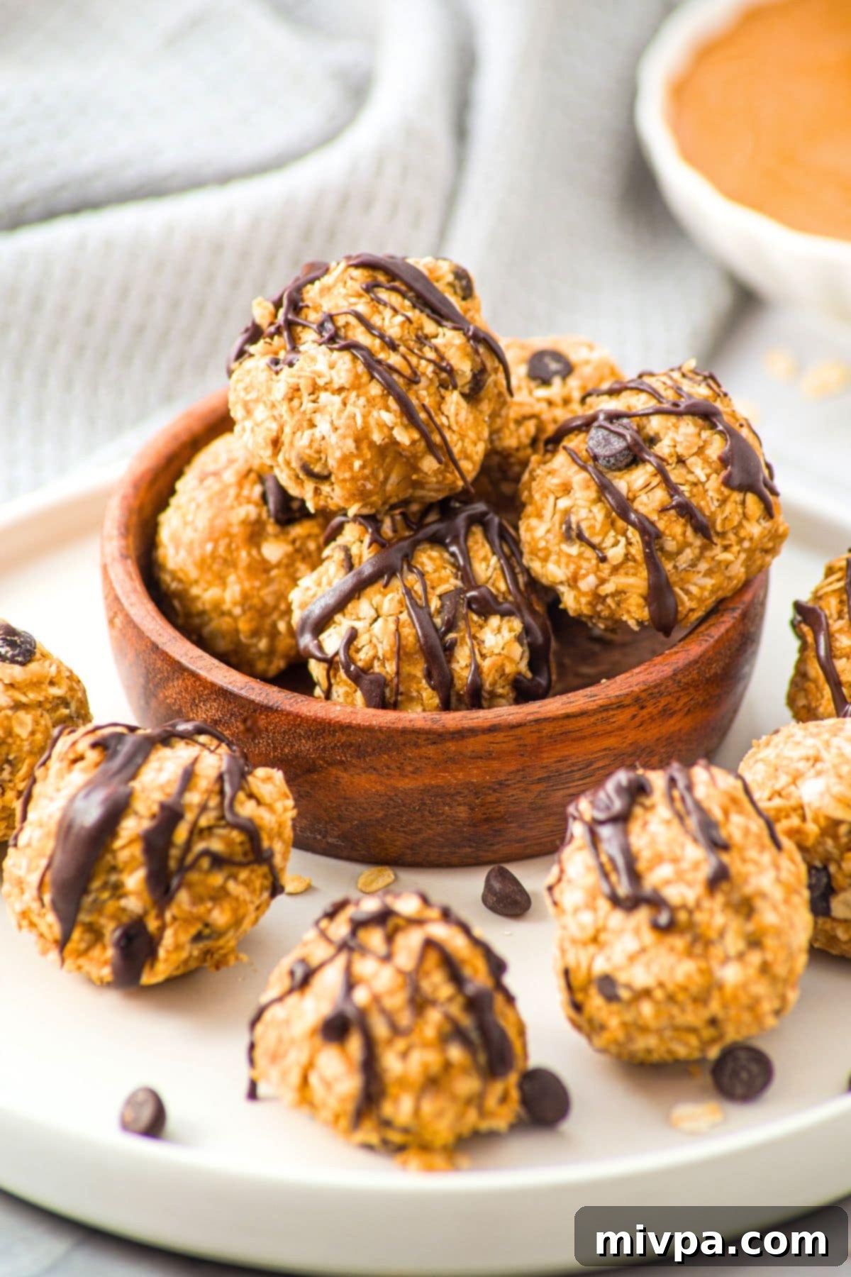 Peanut Butter Oatmeal Balls (Gluten-Free, Vegan) Up close view of peanut butter oatmeal balls in wooden bowl