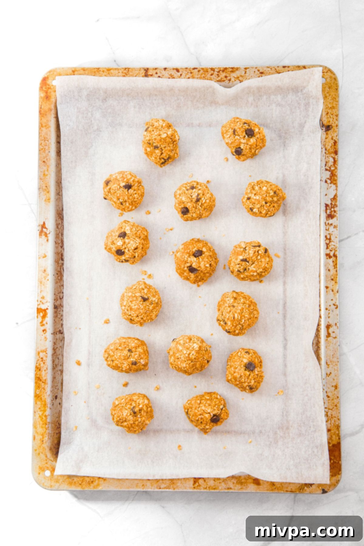 Peanut Butter Oatmeal Energy Balls Peanut butter oatmeal energy balls on parchment-lined baking sheet