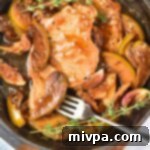 Pan-Seared Apple Pork Harvest 4 Up close shot of pork chops and caramelized apples in skillet.